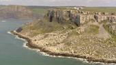 Limestone layers slipping down over soft mudstone layers beneath, Dorset.