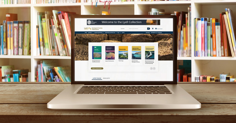 An open laptop in a library open with the Lyell page