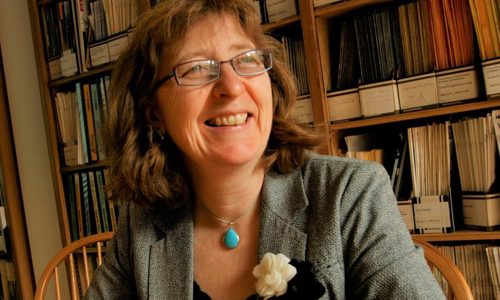 Ruth Allington, Geological Society President 2023-24, seated in front of bookshelves