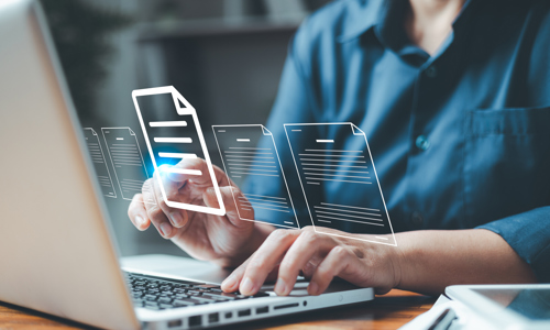 laptop with man's hand touching it and transparent digital documents in front of the screen