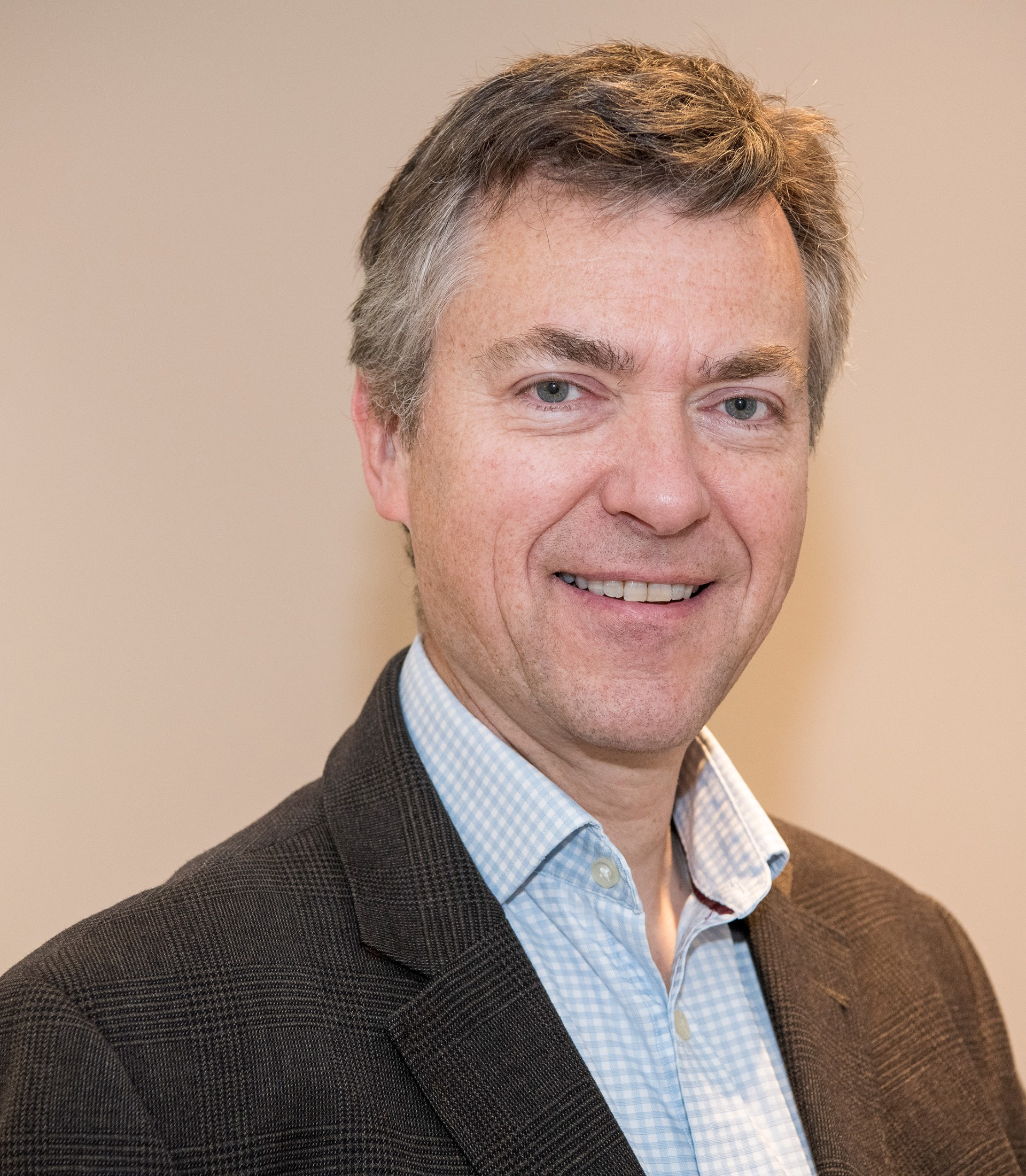 Professional photo of a personal in front of a plain background