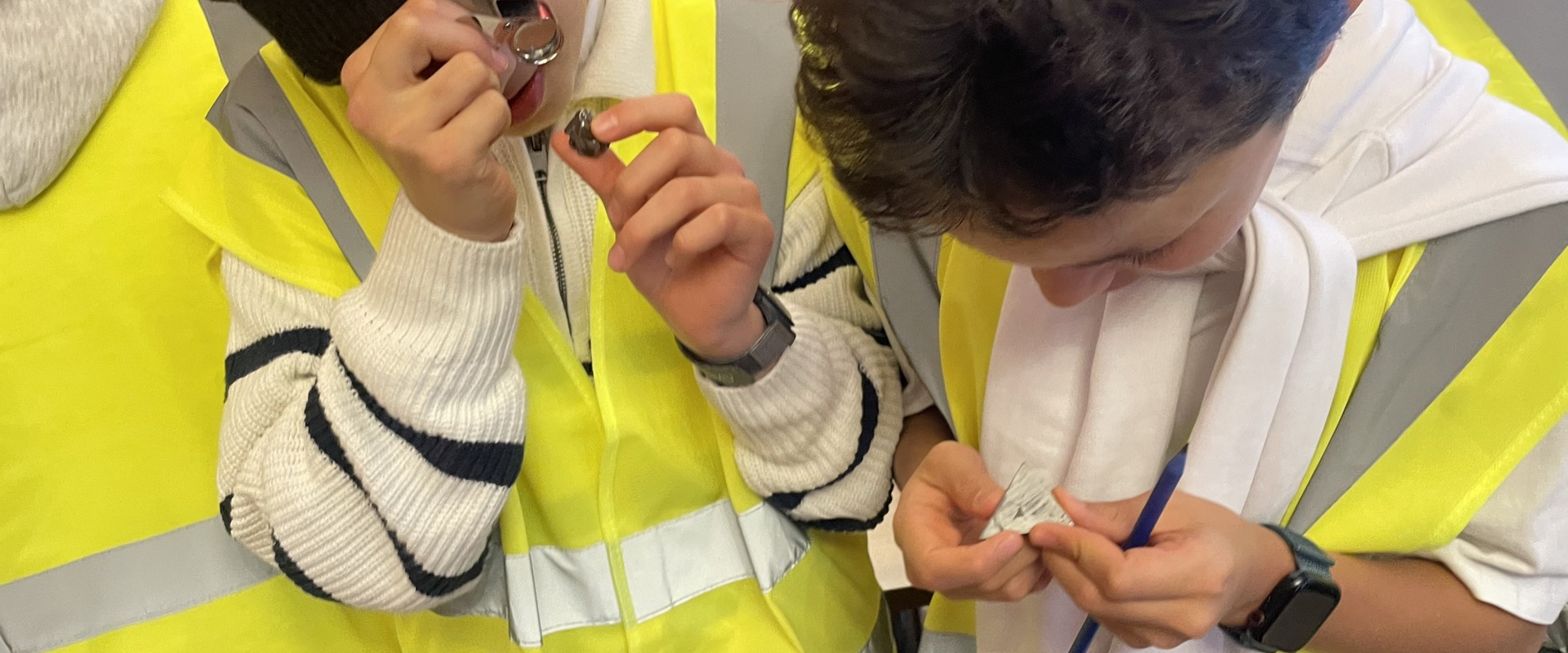 two children in high vis jackets