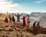 Friends on a mountaintop cheering