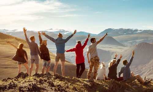 Friends on a mountaintop cheering