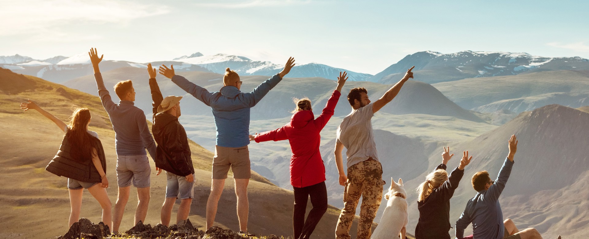 Friends on a mountaintop cheering