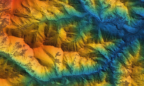 view of mountain range in various colours from above