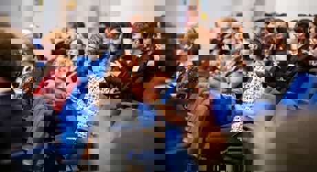 Attendees at a conference clapping in appreciation, reflecting a positive atmosphere and active participation in the event.