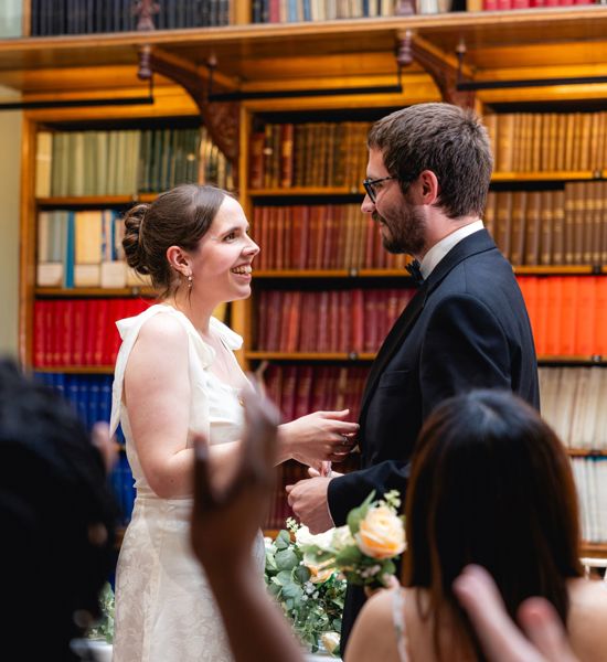 Guests were clapping for the bride and the groom during the wedding ceremony in the Lower Library