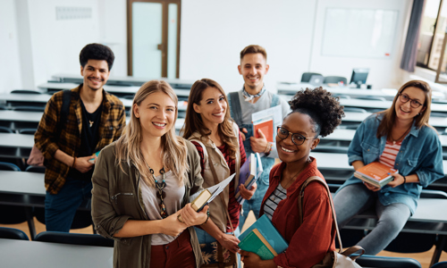 group of male and female students of differing ethnicities in a university classroom