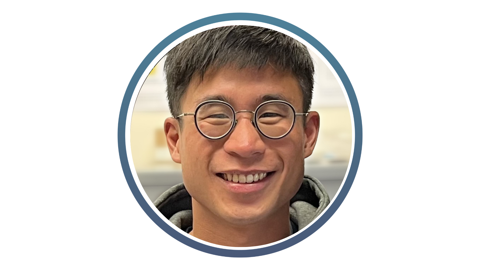young asian man wearing glasses and smiling with sort dark hair