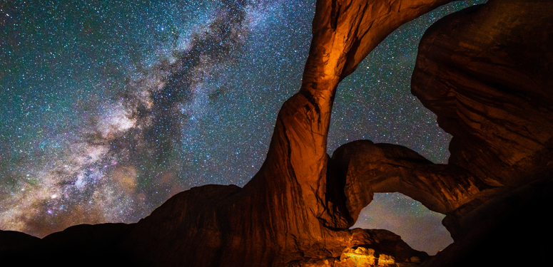 Milky Way Galaxy behind Double Arch sandstone rock formation in Arches, National Park, Utah