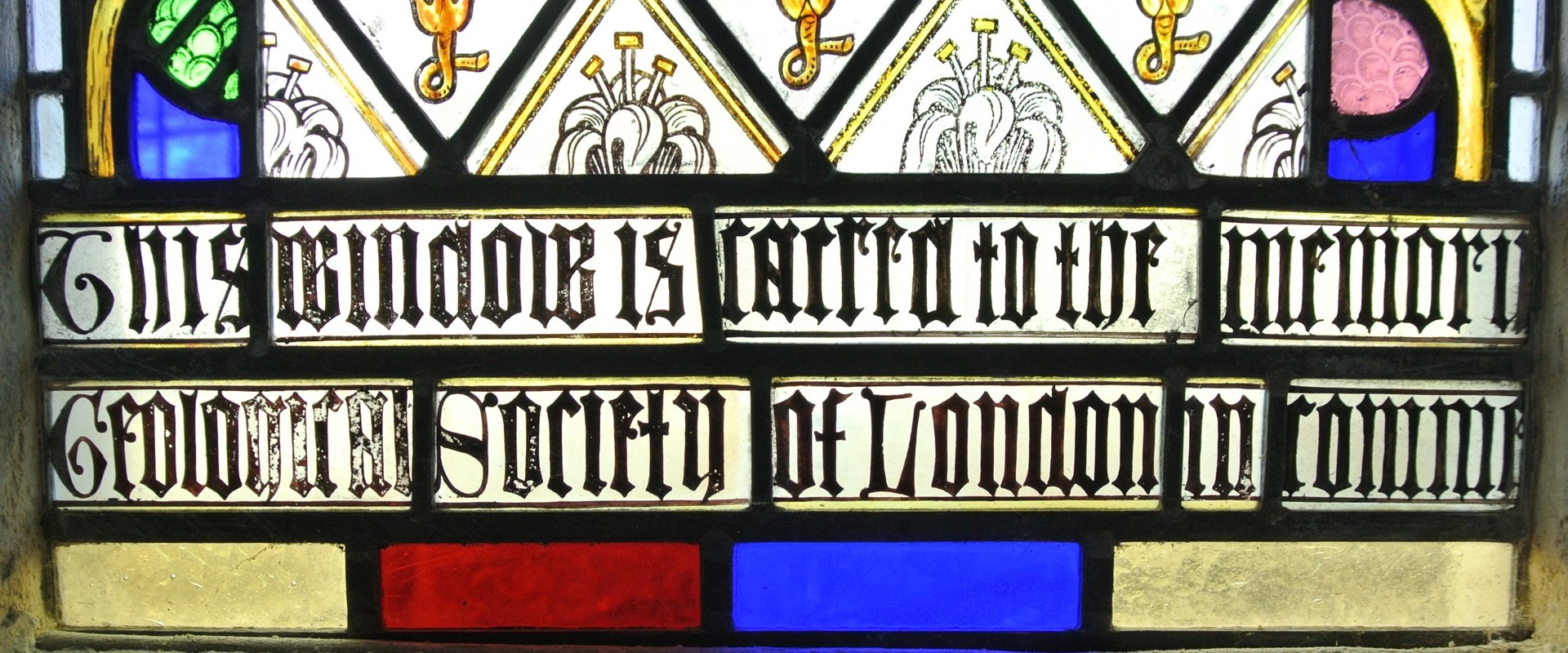 Detail of the memorial stained glass window at Lyme, citing the Geological Society