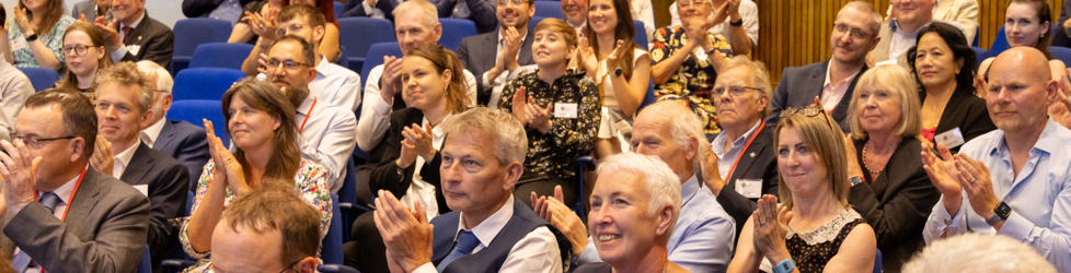 Members of the audience at a Geological Society Awards ceremony clapping