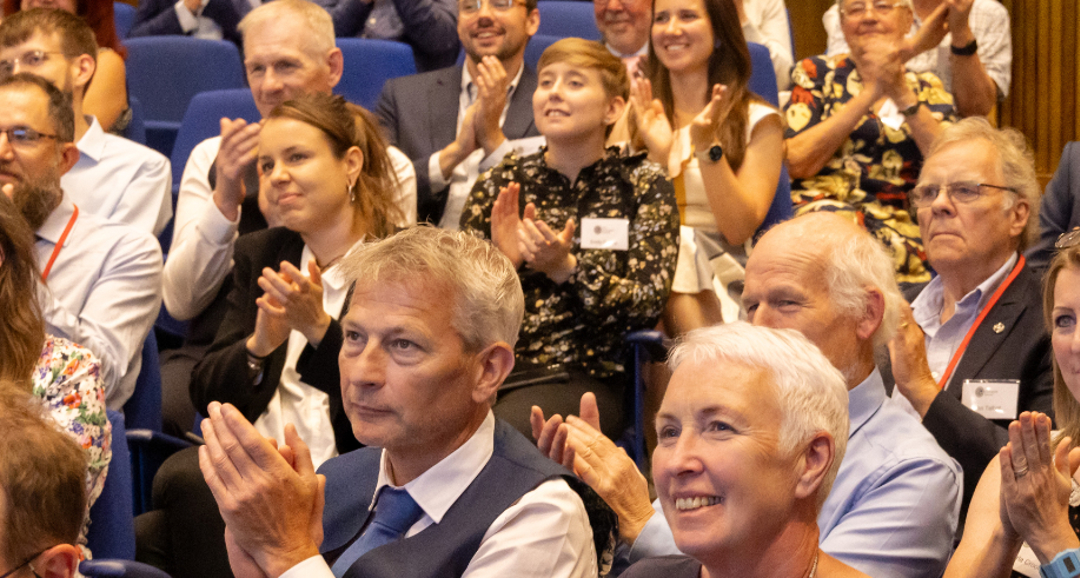 Members of the audience at a Geological Society Awards ceremony clapping