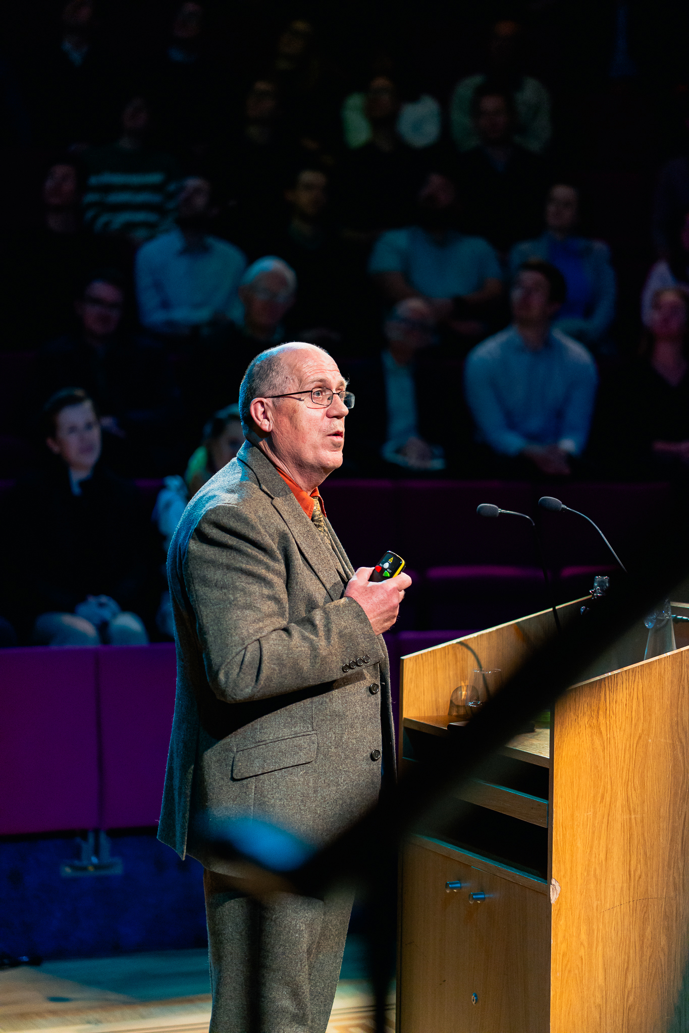 man with glasses and balding hair speaking from a podium
