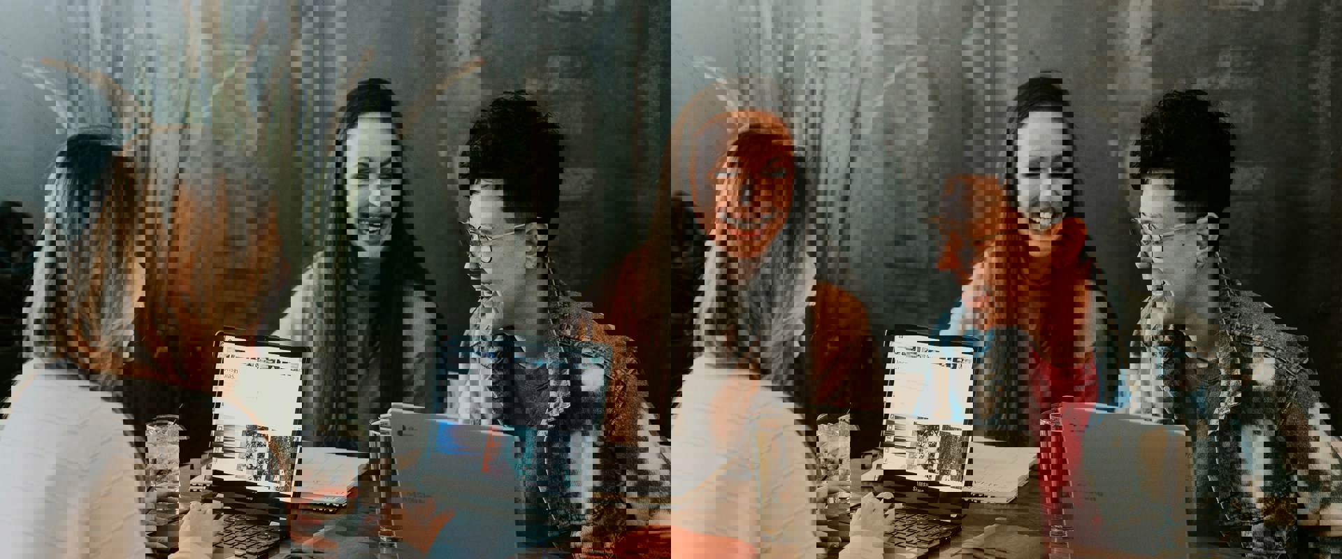 three women working at their laptops together, all smiling