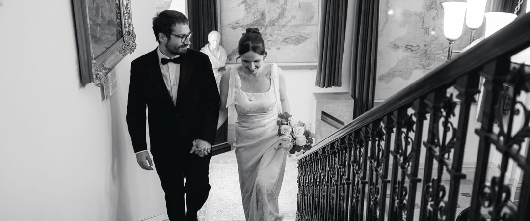 The Bride and the Groom were holding hands together at the Grand Staircase