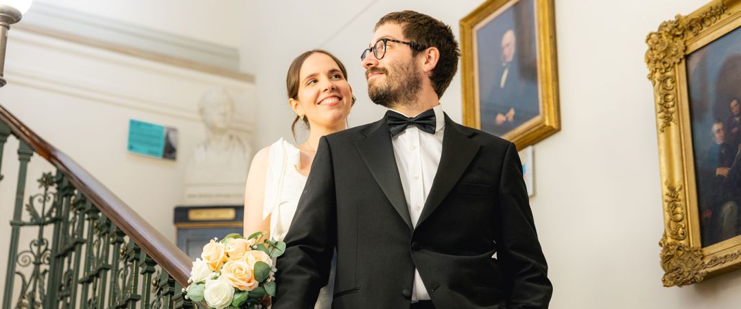 The Bride and the Groom were both smiling each other at the Grand Staircase