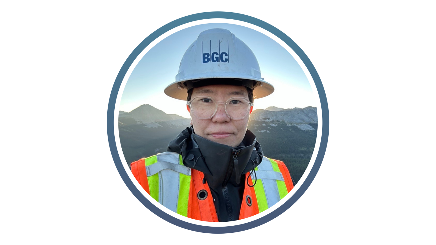 person wearing a hard hat with bgc on it and high vis jacket