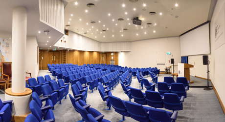 blue seats in a lecture theatre