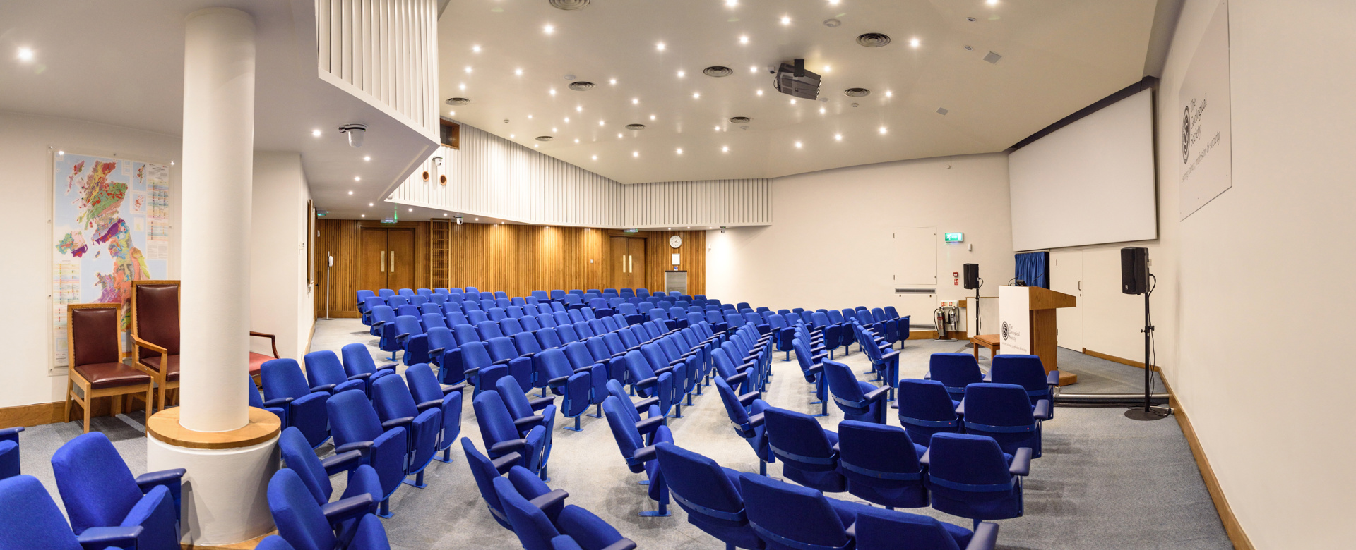 blue seats in a lecture theatre