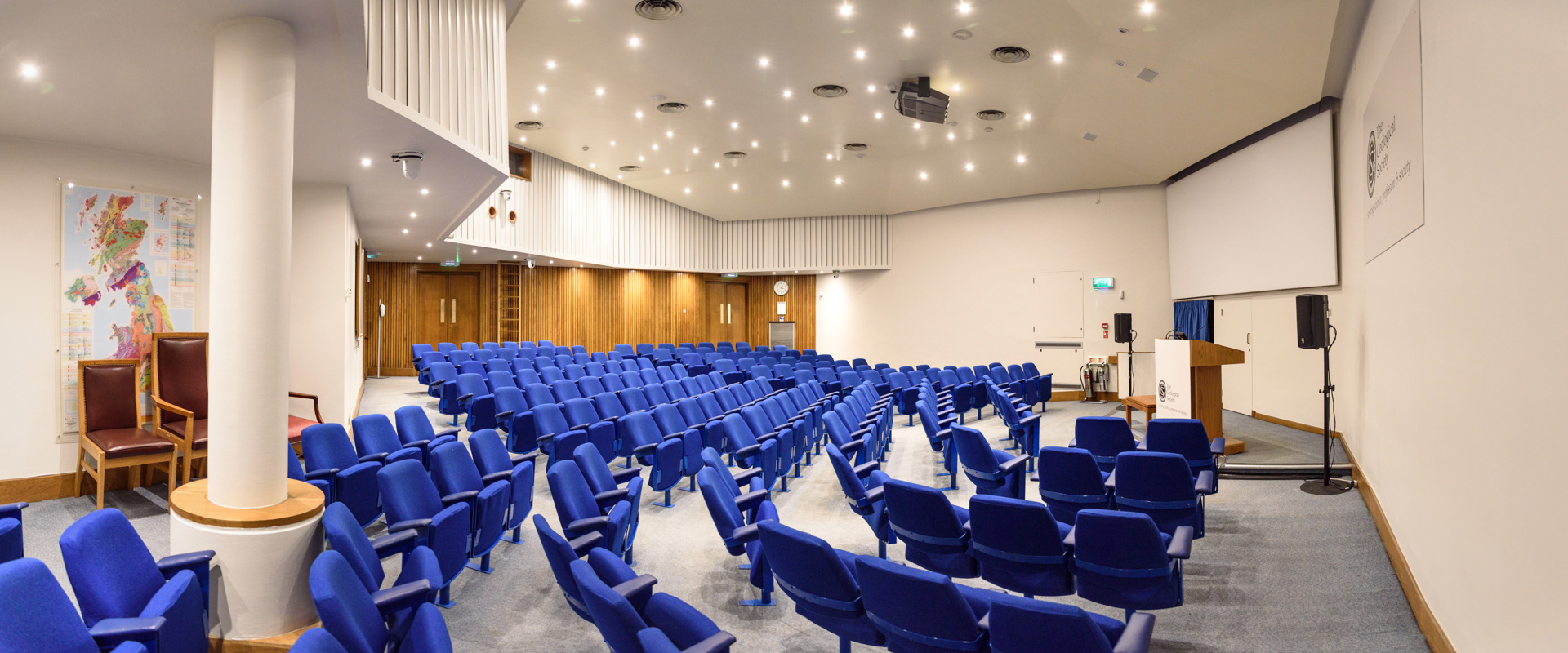 blue seats in a lecture theatre