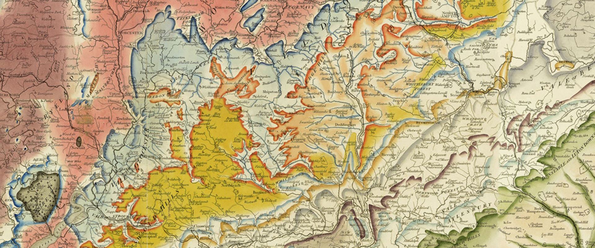 A rectangular extract from William Smith's geological map, showing geological colouring in reds, blues, yellows and greens