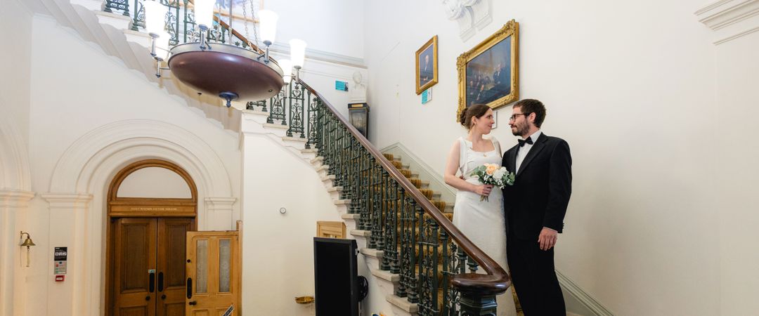 The Bride and the Groom were both standing at the Grand Staircase, looking at each other.