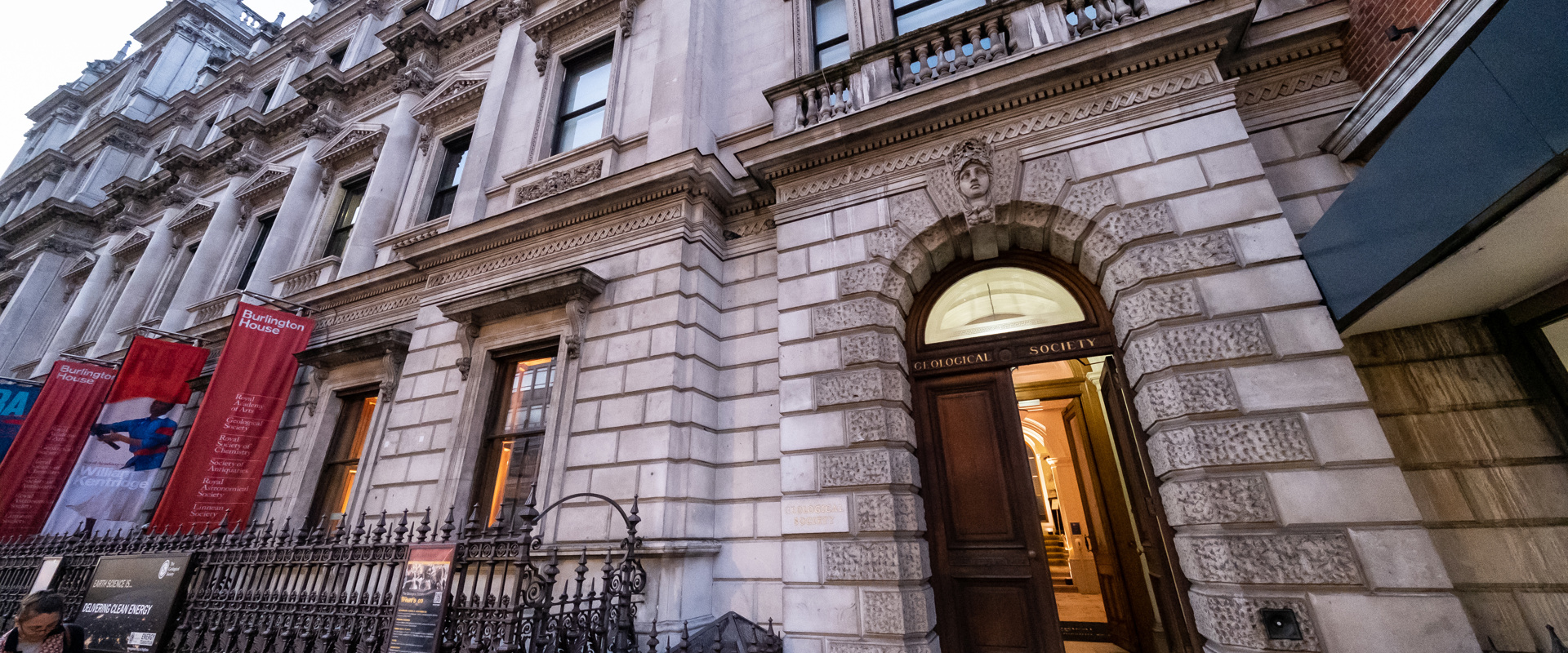 period building with large open wooden doors with geological society placard above them