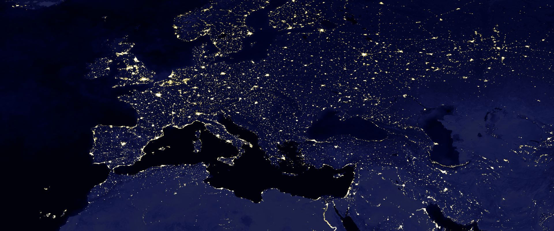 A view of Europe from space at night, showing the lights of cities and other urban areas