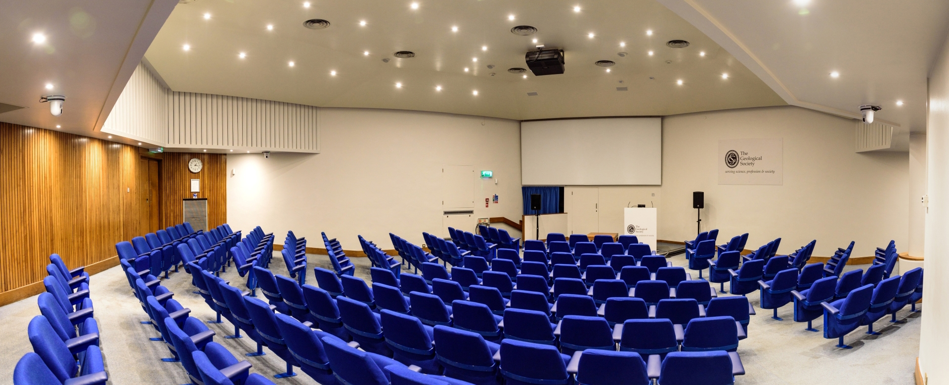 A 172-seat Lecture Theatre with blue chairs and a large projector screen.