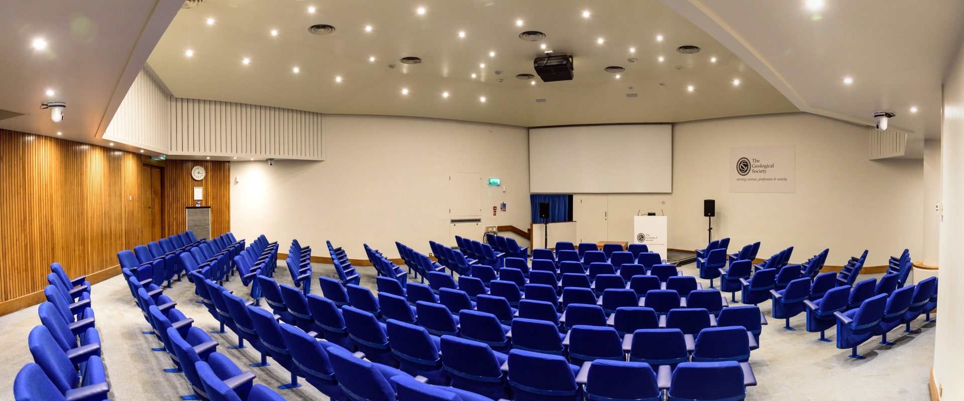 A 172-seat Lecture Theatre with blue chairs and a large projector screen.