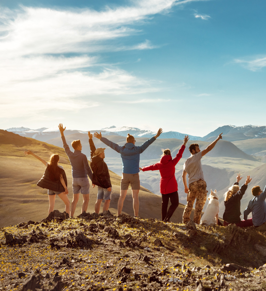 Friends stood on a mountaintop cheering