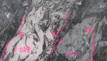 Rock face with mineral veins and markings on formation