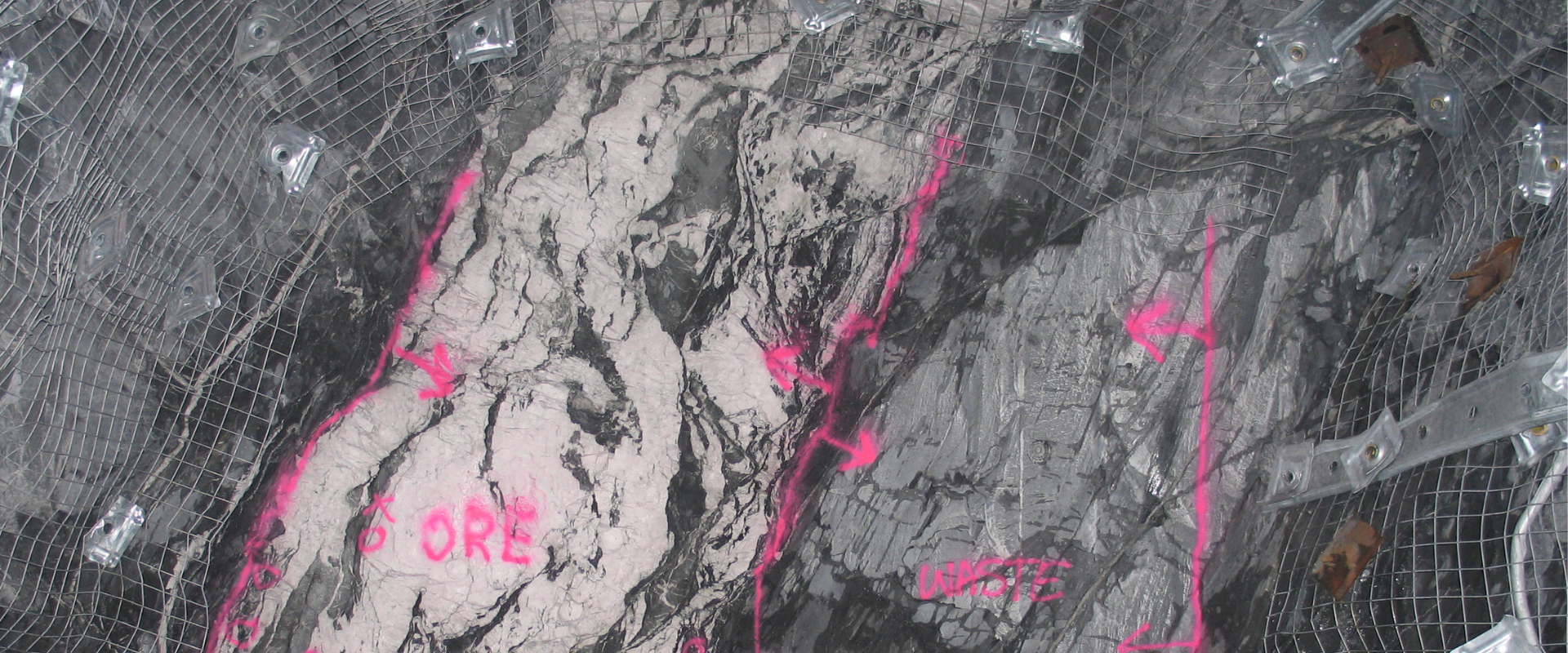 Rock face with mineral veins and markings on formation