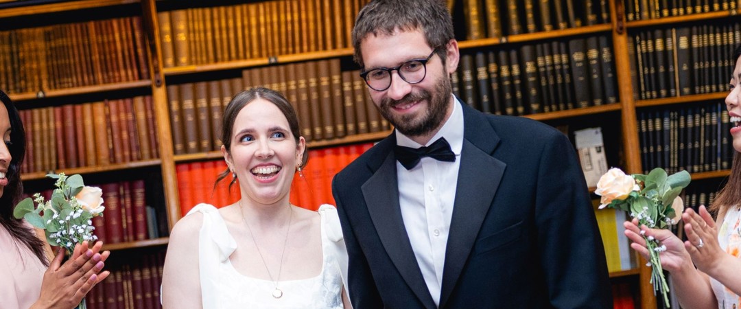 The bride and groom walking down the aisle in the Lower Library.