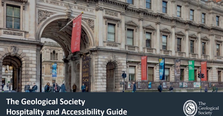 Exterior of a historic stone building with archways and decorative banners. People walk beneath. Text reads "The Geological Society Hospitality and Accessibility Guide."