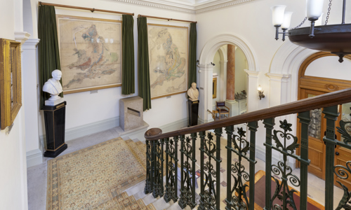 Large Hallway with grand staircase and a map of the UK 