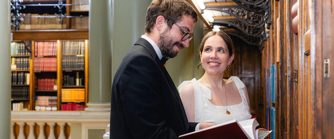 The bride and groom were reading a book at the Upper Library.